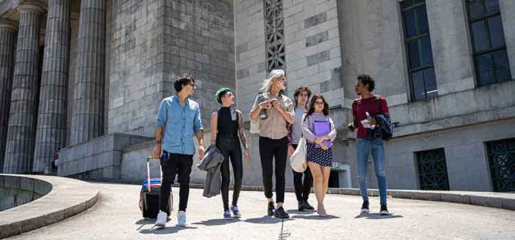 professor leading group of potential business students on college campus tour