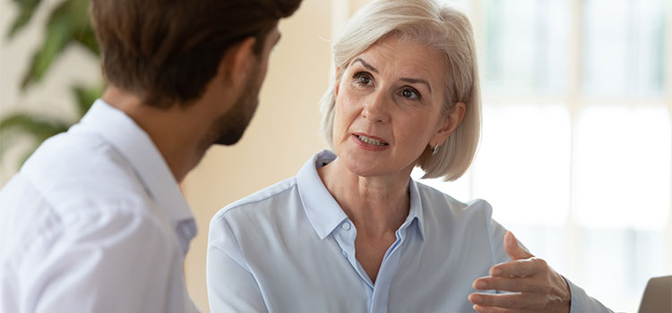 woman speaks with co-worker