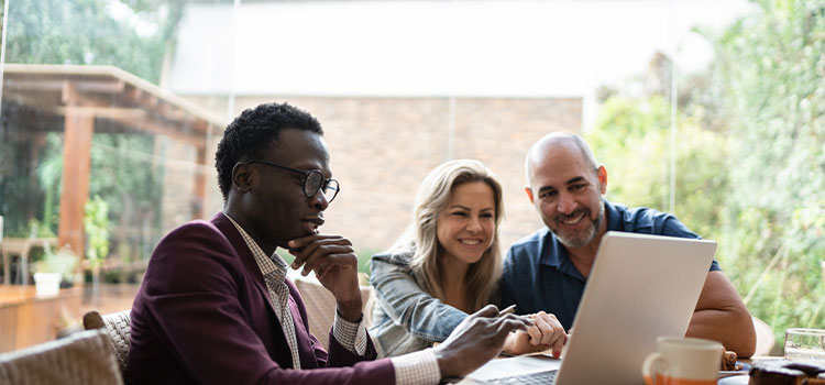 A professional goes over his work with two clientsith