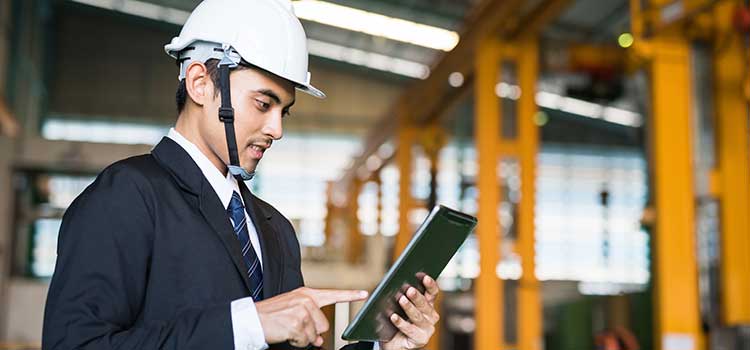 businessman records data while doing a plant inspection in texas