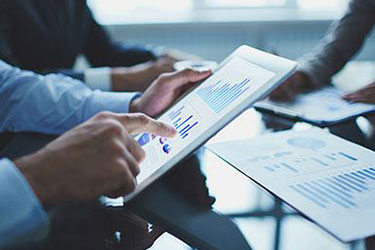 hands showing profit graph on tablet