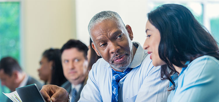 An instructor talks to a student during class