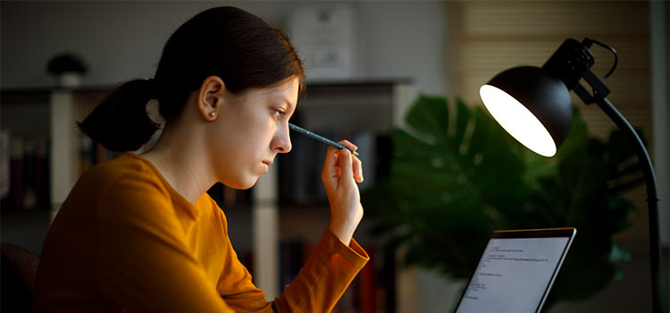 a woman studies on her laptop