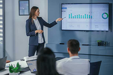female financial manager presents financial statistics at a company meeting