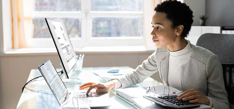 professional woman at desk on laptop
