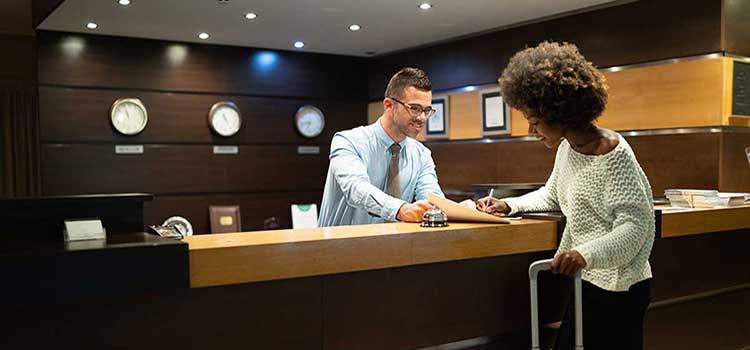 hospitality hotel manager presents guest with charges