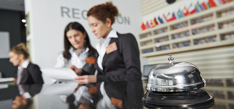 hotel manager shows desk clerk paperwork