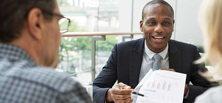 insurance agent shows numbers to clients
