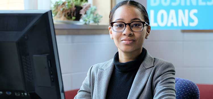 female loan officer sits at computer