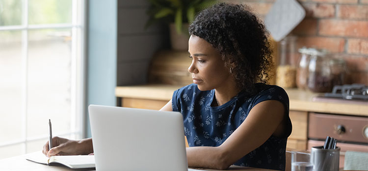 A woman does research on her laptop