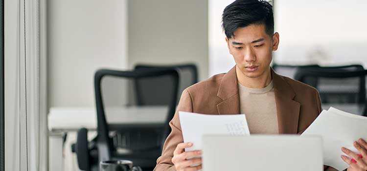 business student looks over masters thesis