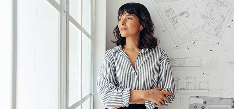 business administrator stands in front of development plans for ohio town