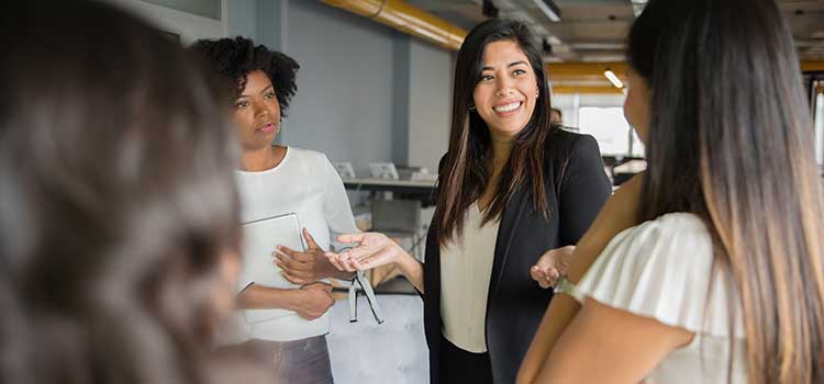 female sports agent discussing work with coworkers