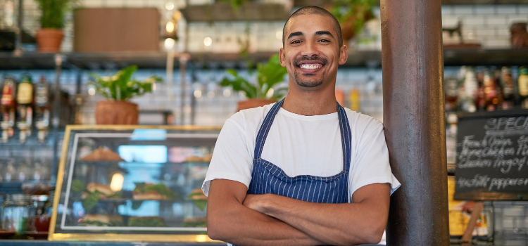 cafe owner smiling in his shop